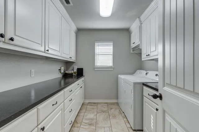 a kitchen with granite countertop a sink and a stove top oven
