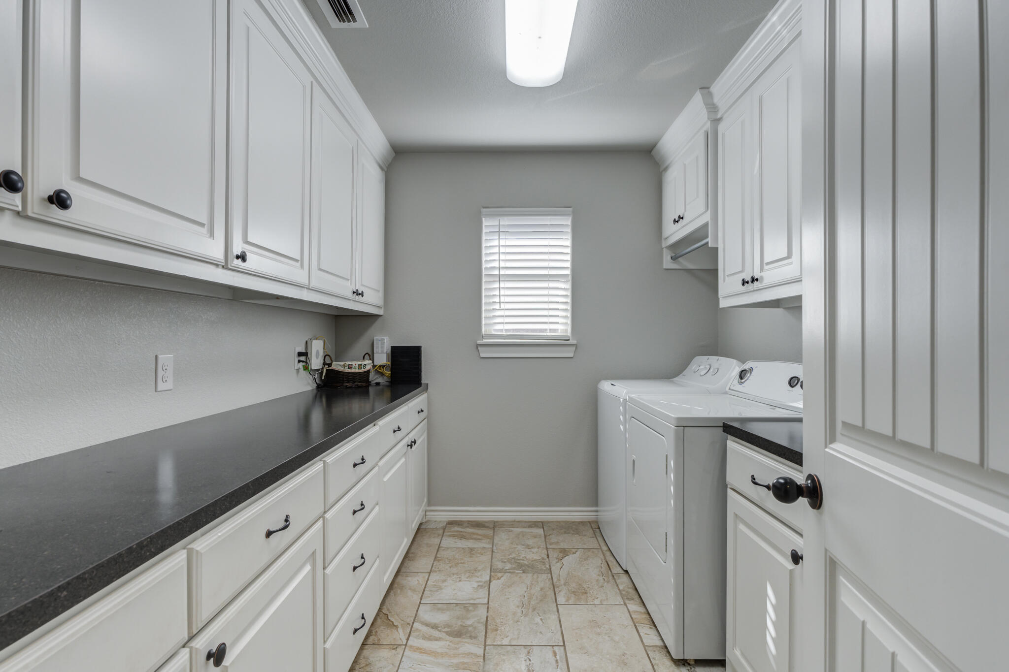 6306 87th Street Lubbock, TX 79424 - Photo 24 of 47 a kitchen with granite countertop a sink and a stove top oven