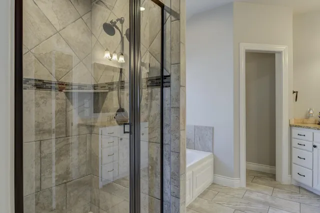 a bathroom with a shower and a sink