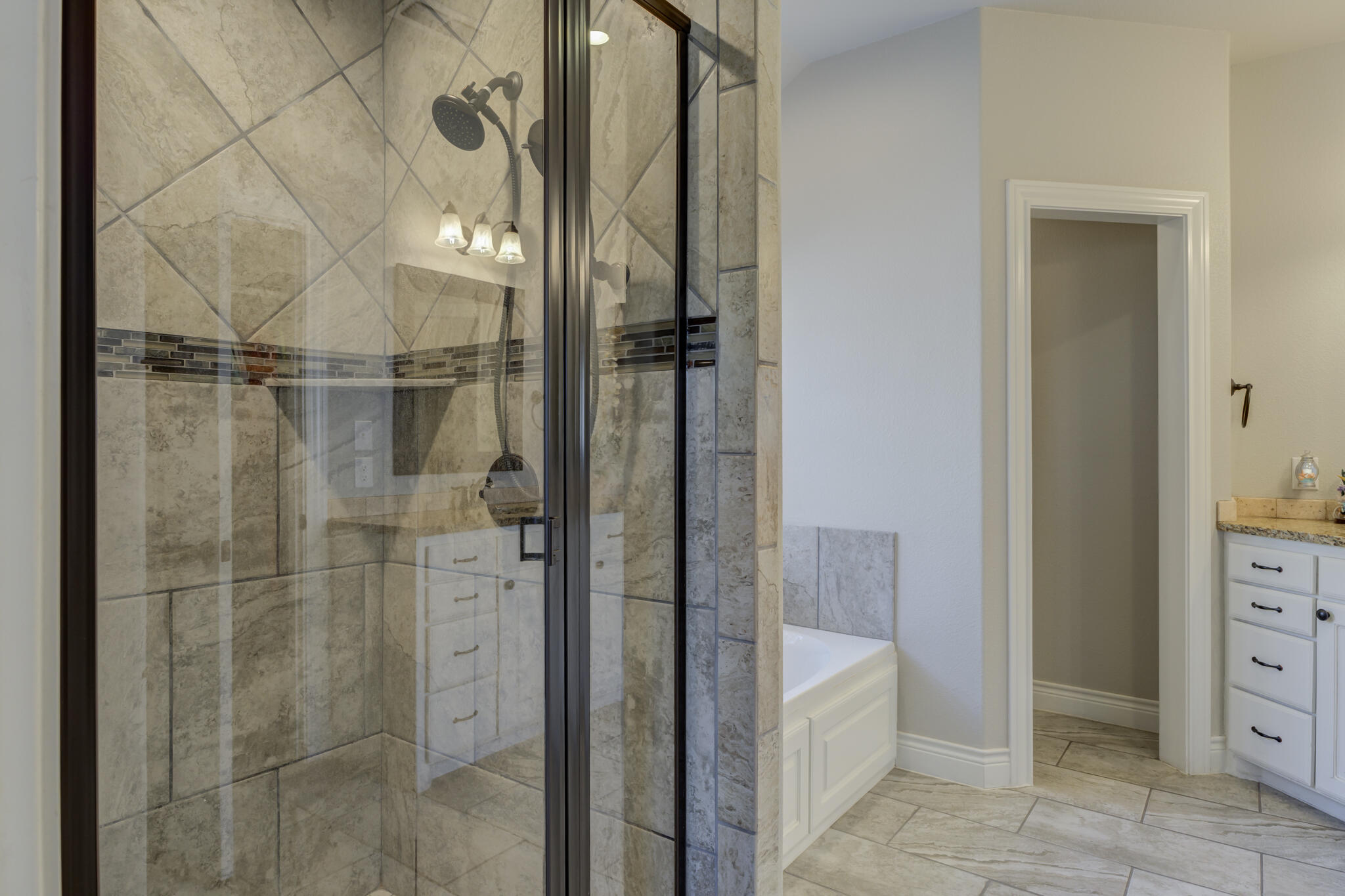 6306 87th Street Lubbock, TX 79424 - Photo 29 of 47 a bathroom with a shower and a sink