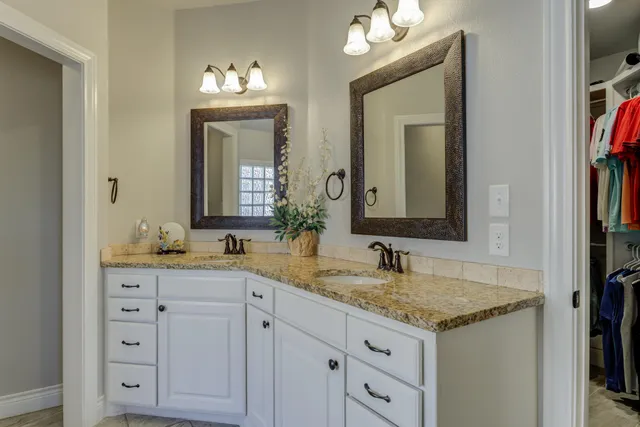 a bathroom with double sink and a mirror