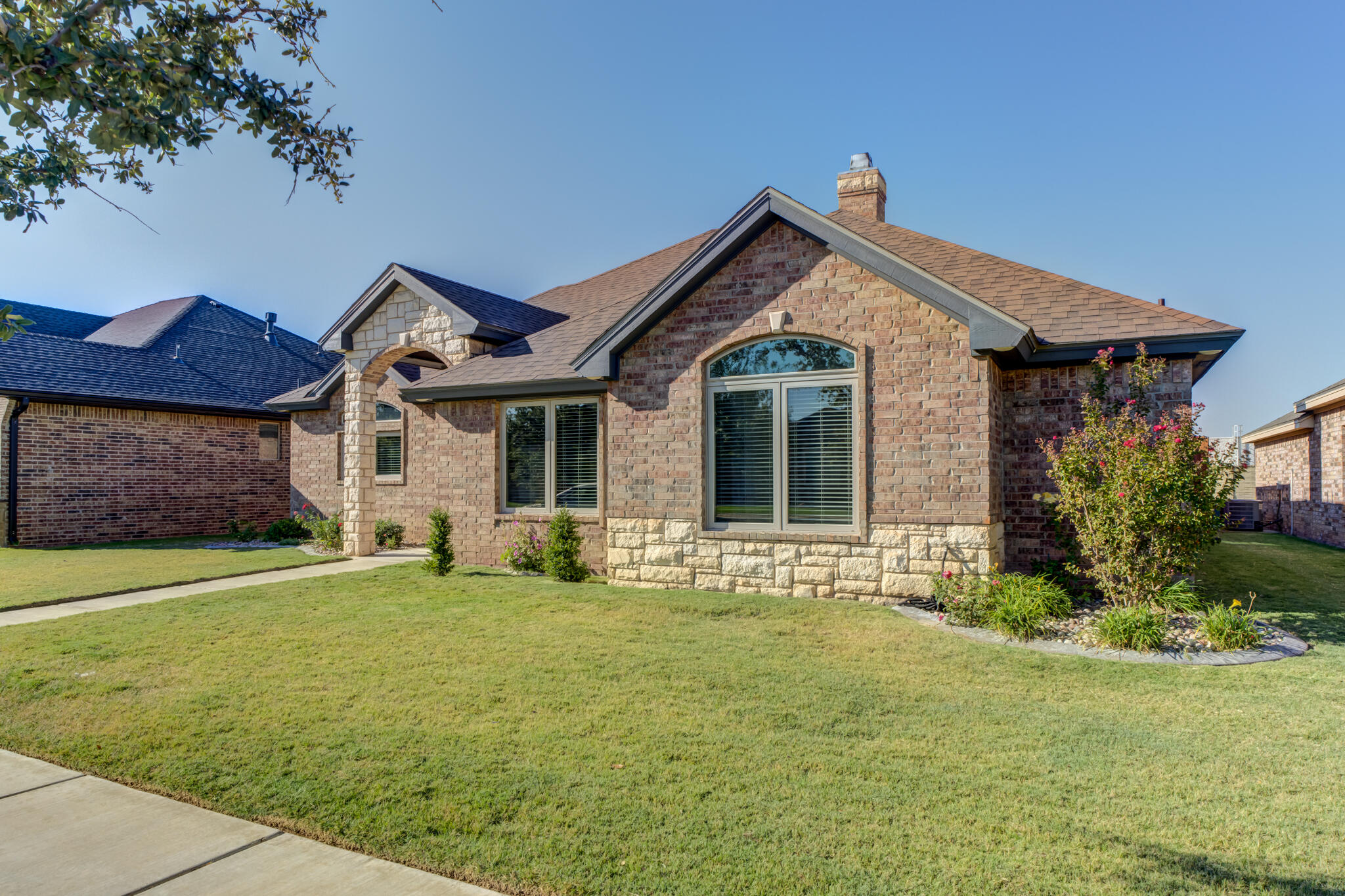 6306 87th Street Lubbock, TX 79424 - Photo 3 of 47 a front view of a house with a yard and garage