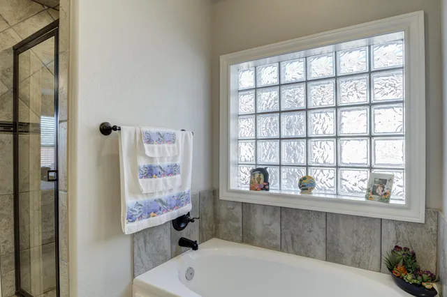 a bathroom with a bathtub and window