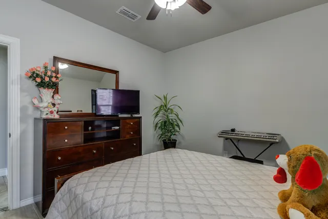 a bedroom with a bed and a chandelier