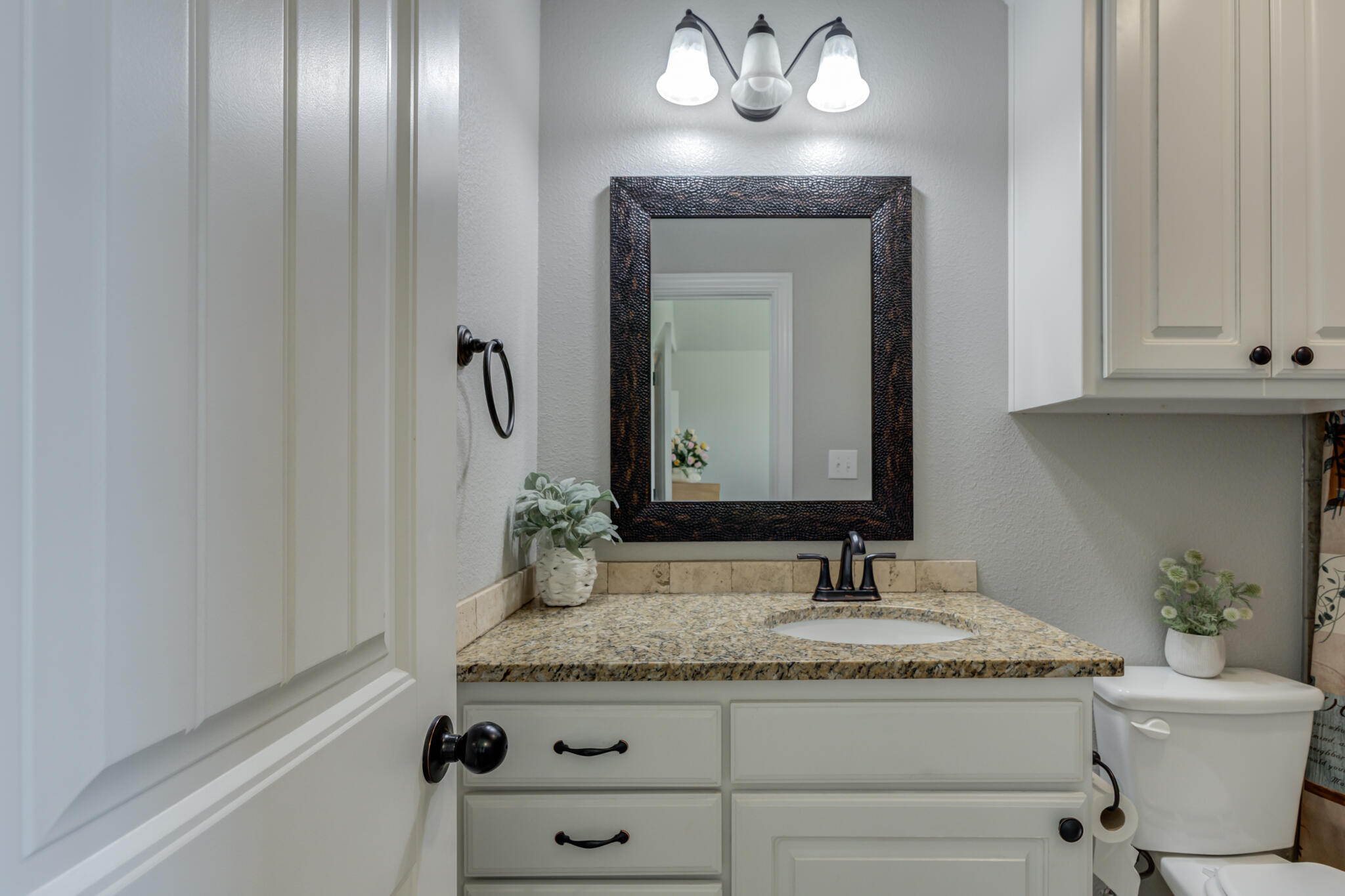 6306 87th Street Lubbock, TX 79424 - Photo 39 of 47 a bathroom with a granite countertop sink and a mirror