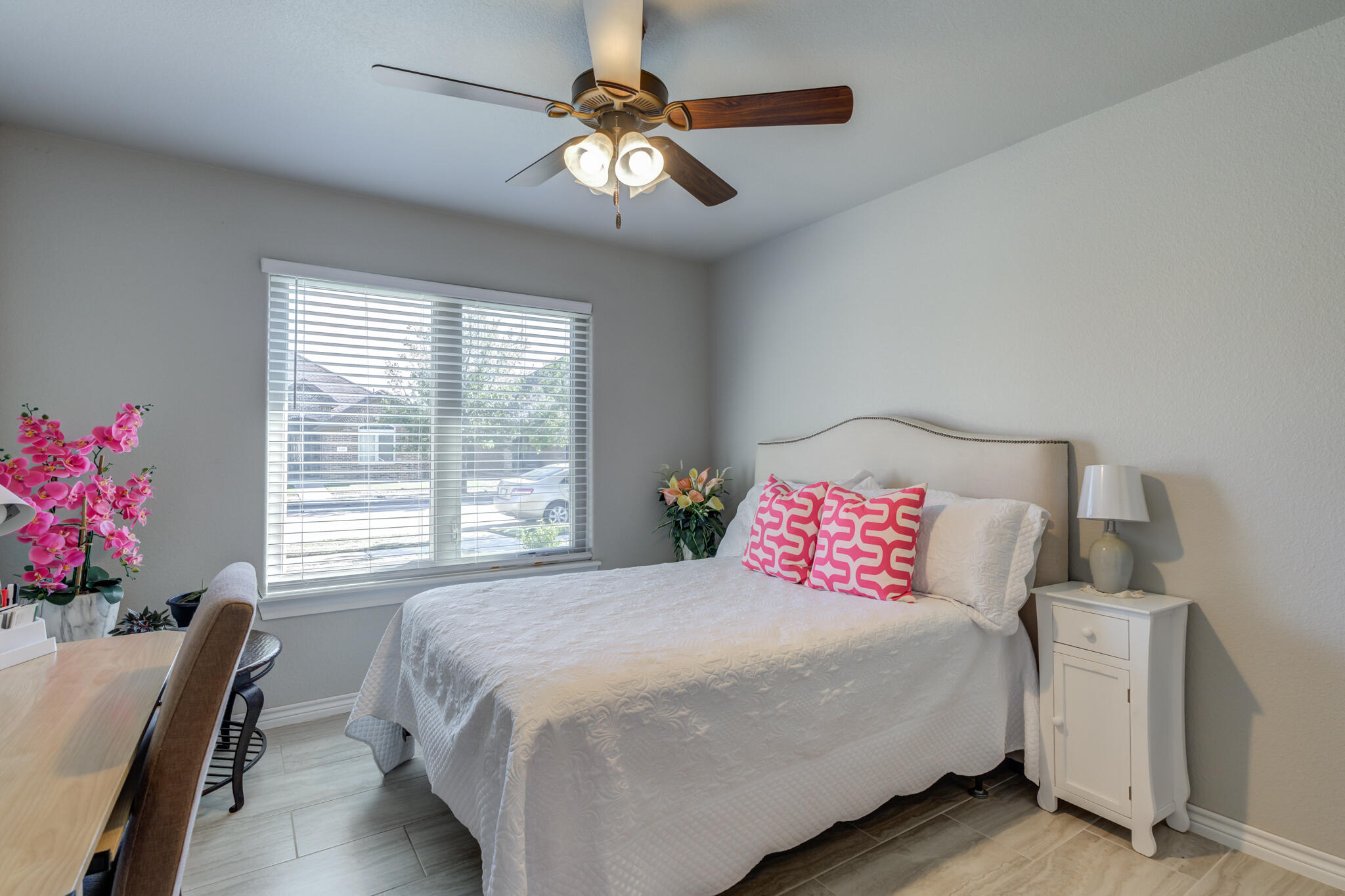 6306 87th Street Lubbock, TX 79424 - Photo 41 of 47 a bedroom with a bed and a chandelier