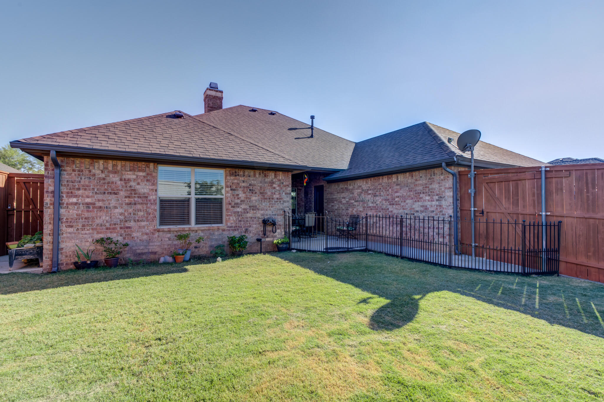 6306 87th Street Lubbock, TX 79424 - Photo 47 of 47 a brick house with garden in front of it