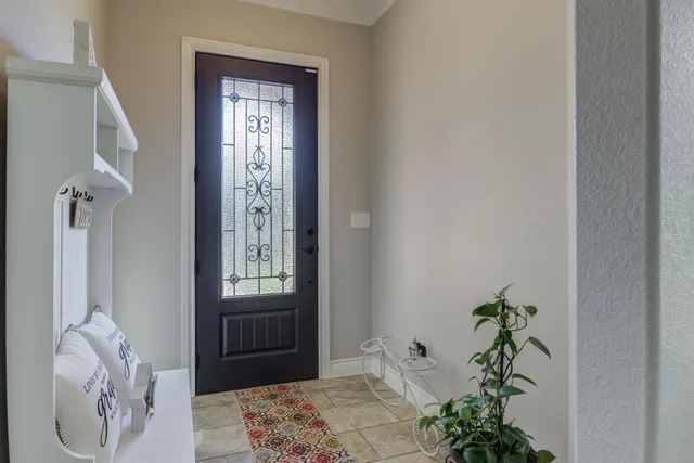 a bedroom with a bed table and a window