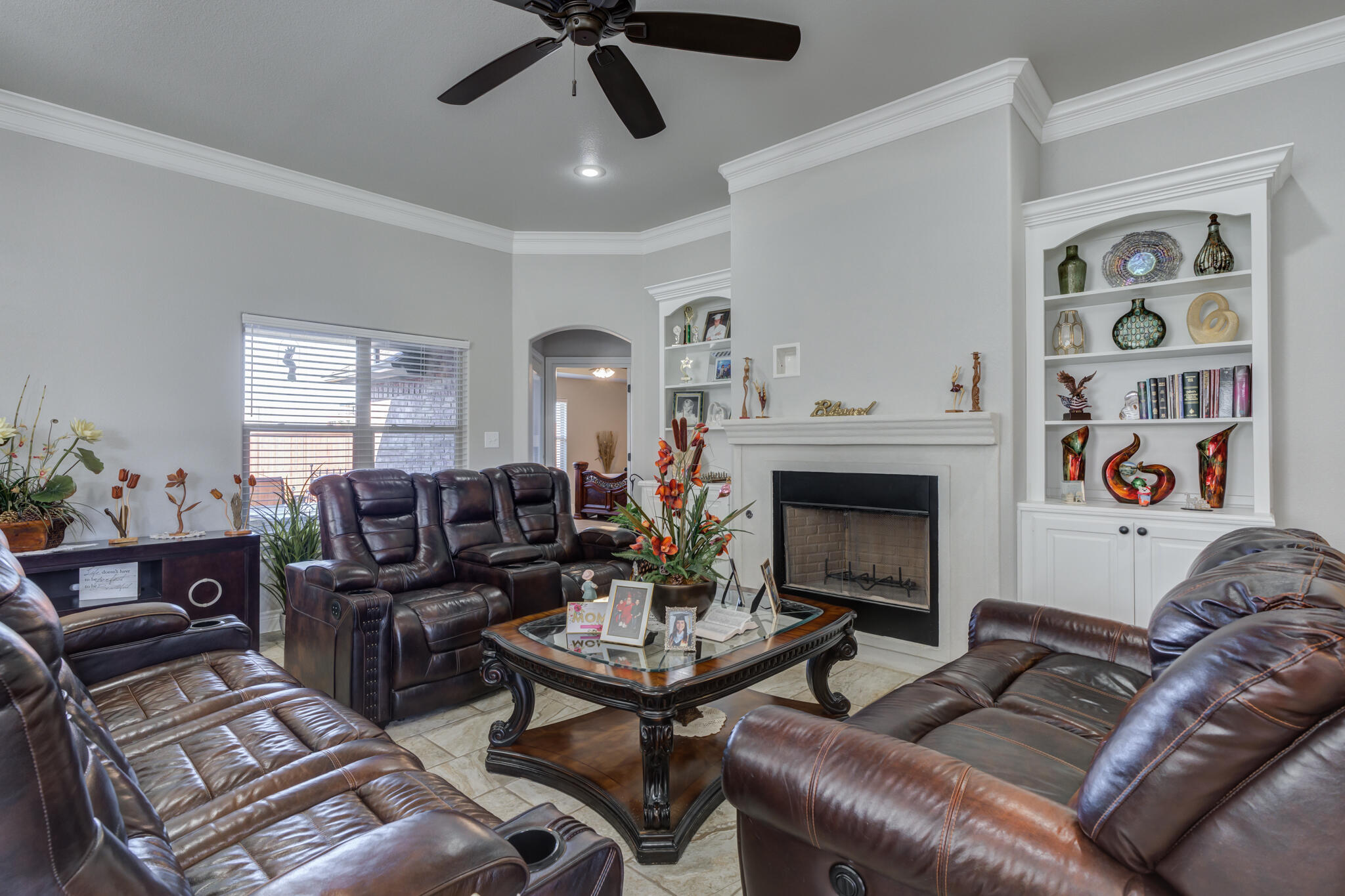 6306 87th Street Lubbock, TX 79424 - Photo 7 of 47 a living room with furniture a flat screen tv and a fireplace