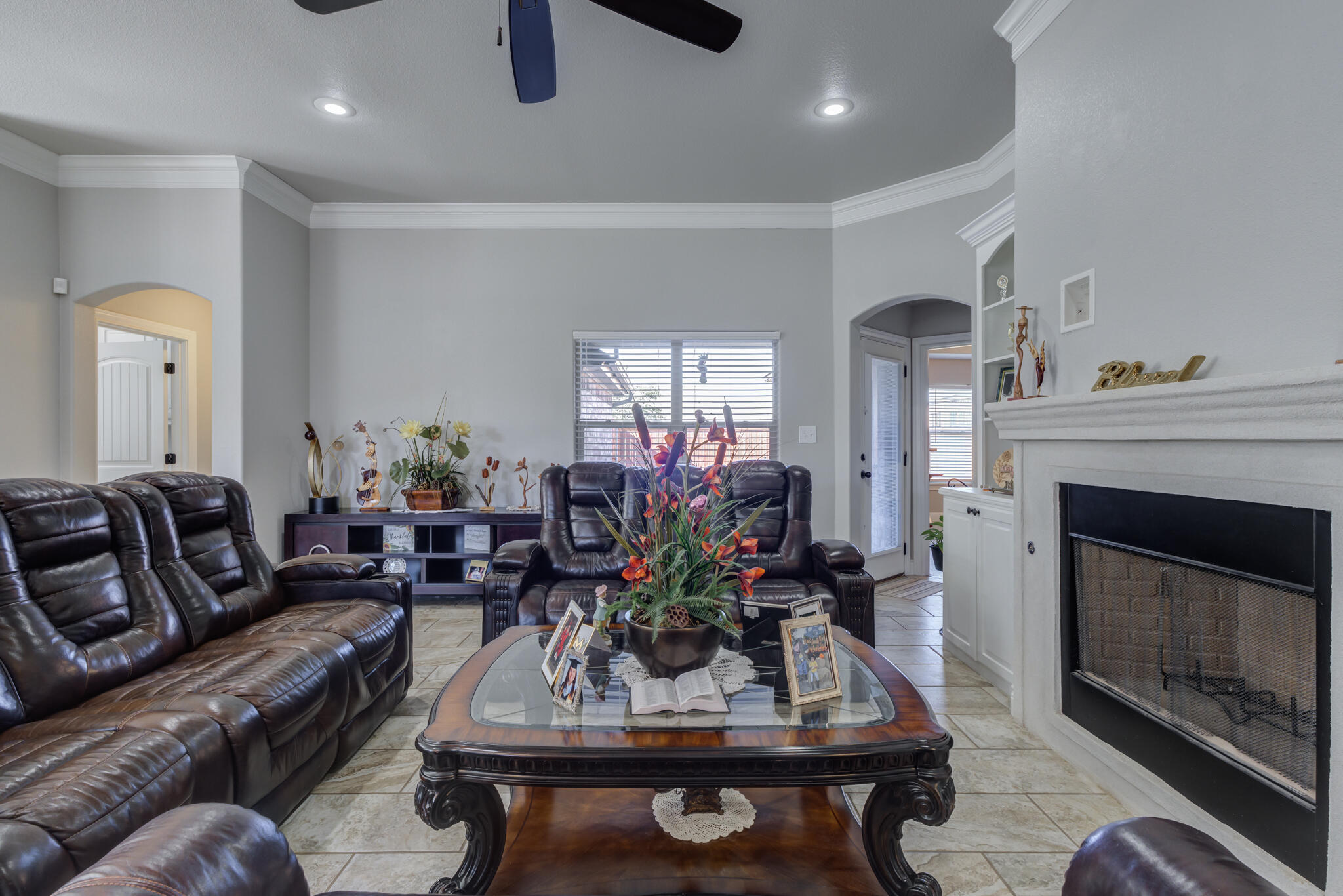 6306 87th Street Lubbock, TX 79424 - Photo 8 of 47 a living room with furniture a fireplace and a chandelier