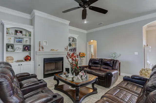 a living room with furniture a fireplace and a window