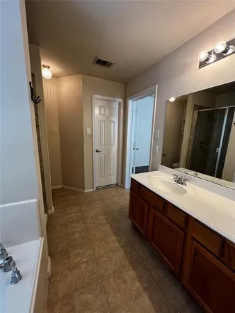 a bathroom with a double vanity sink and mirror