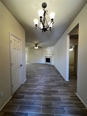 a view of a chandelier fan and wooden floor