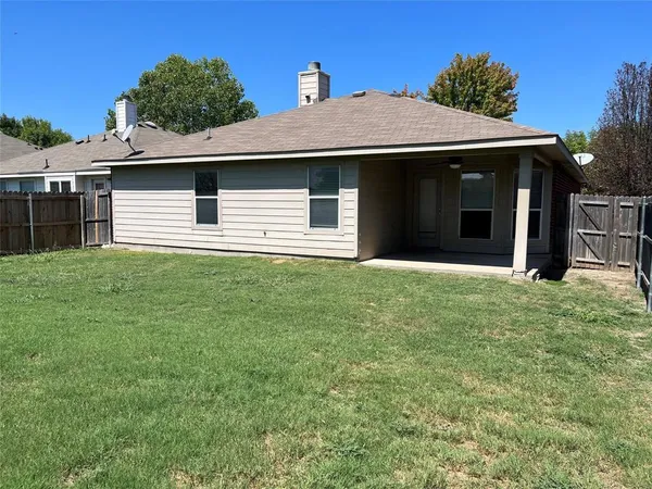 a front view of a house with yard and garage