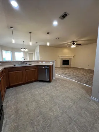 a large kitchen with granite countertop a stove and a sink