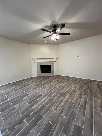 wooden floor in an empty room with a ceiling fan