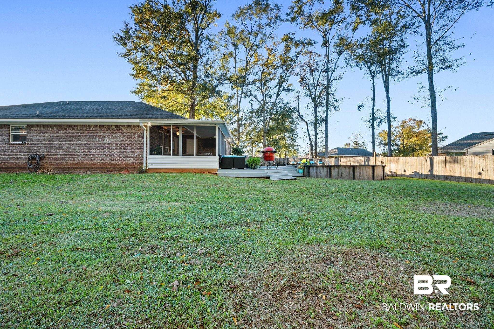 9366 Fox Run Court Semmes, AL 36575 - Photo 28 of 29 View of yard with a swimming pool side deck