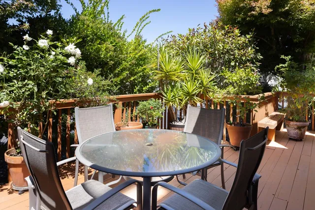 a view of balcony with table and chairs
