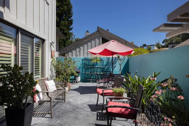 a patio with tables and chairs and a potted plants