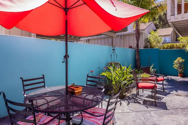 a view of a chairs and table in patio