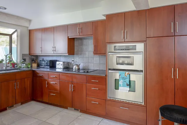 a kitchen with stainless steel appliances granite countertop a refrigerator and cabinets
