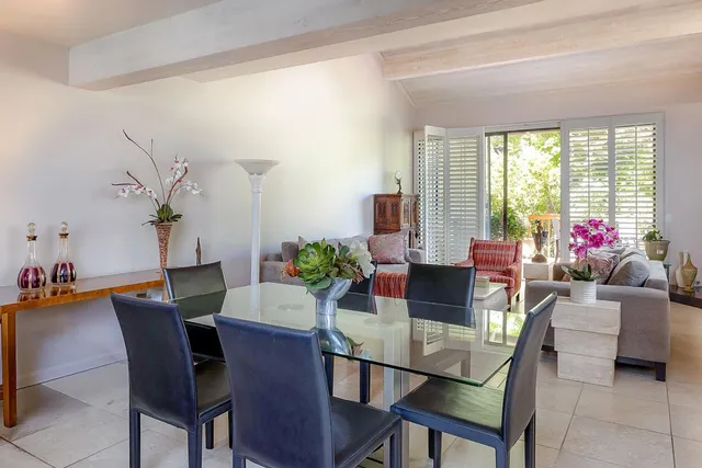 a view of a dining room with furniture and a potted plant