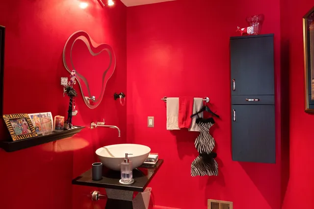 a bathroom with a mirror and a sink