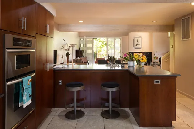 a kitchen with a counter space a sink appliances and cabinets