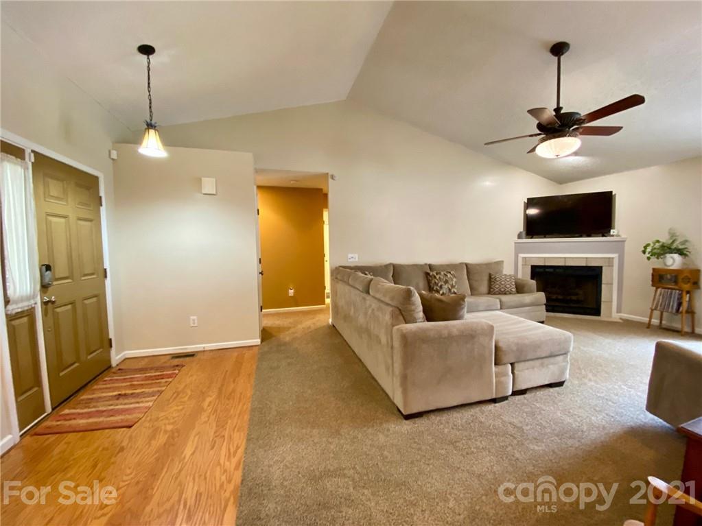 1168 Balfour Quarry Road Salisbury, NC 28146 - Photo 17 of 47 a living room with furniture a fireplace and a flat screen tv