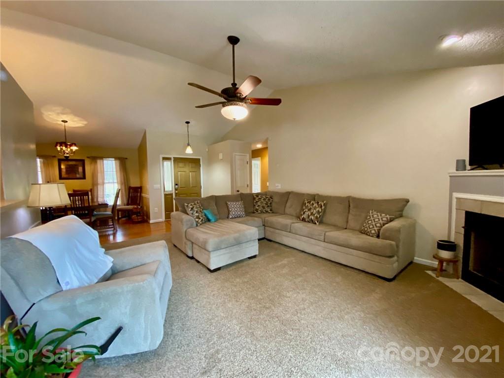 1168 Balfour Quarry Road Salisbury, NC 28146 - Photo 18 of 47 a living room with furniture a fireplace and a flat screen tv