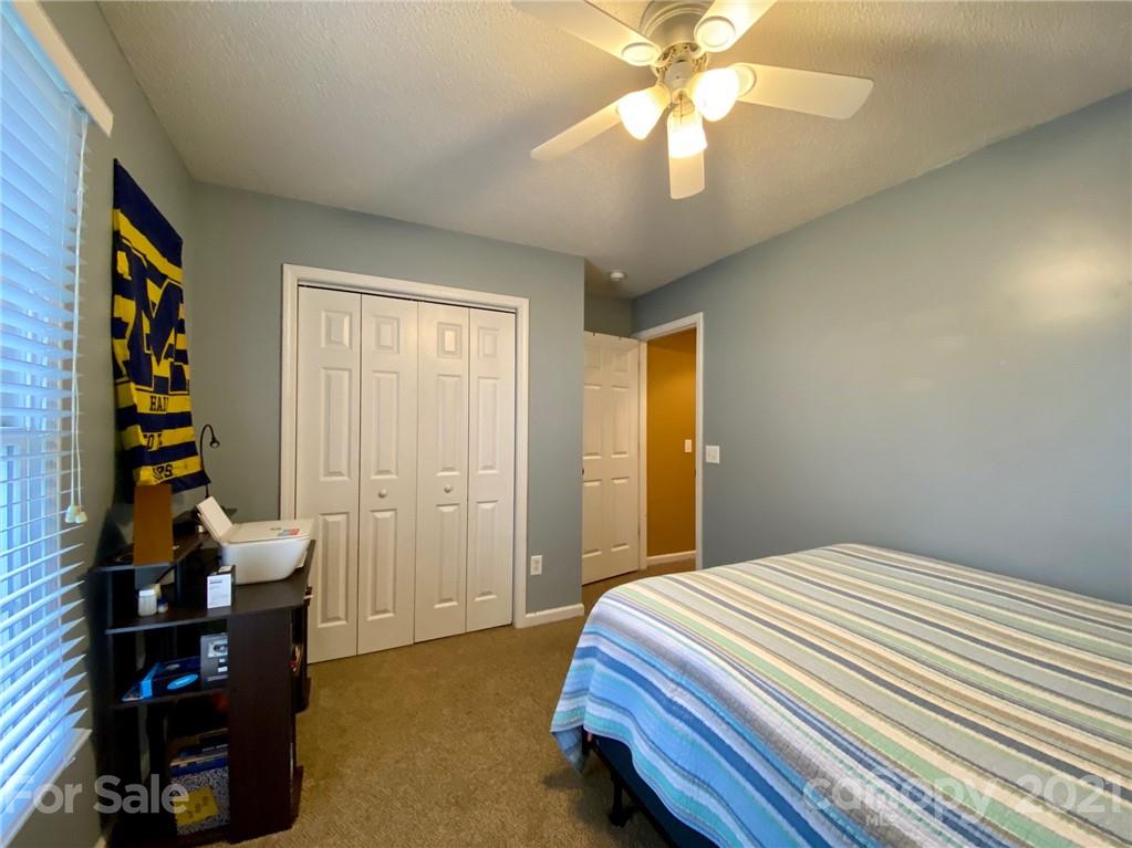1168 Balfour Quarry Road Salisbury, NC 28146 - Photo 27 of 47 a bedroom with a bed and a chandelier