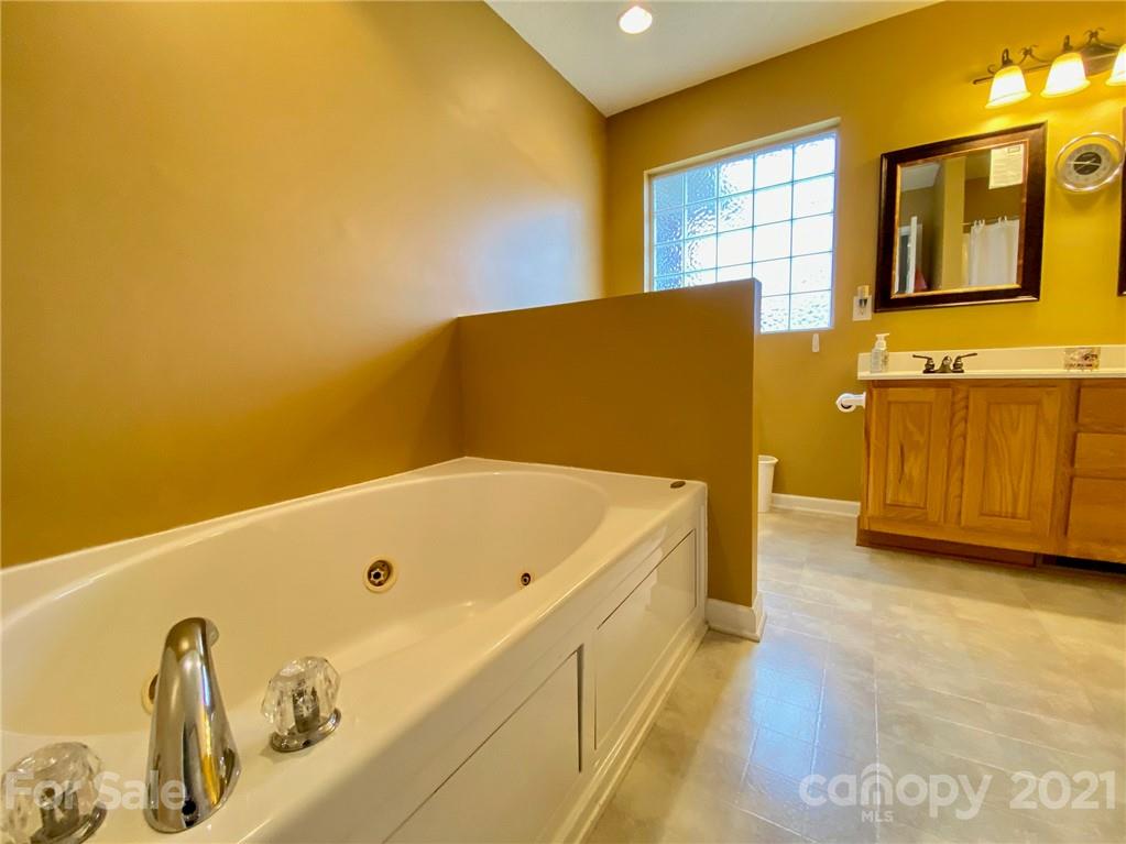 1168 Balfour Quarry Road Salisbury, NC 28146 - Photo 29 of 47 a bathroom with a tub sink and a window