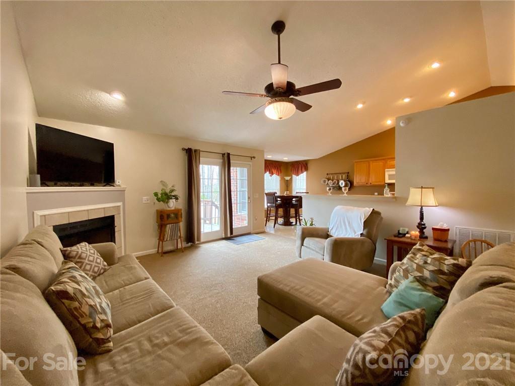 1168 Balfour Quarry Road Salisbury, NC 28146 - Photo 36 of 47 a living room with furniture a fireplace and a flat screen tv