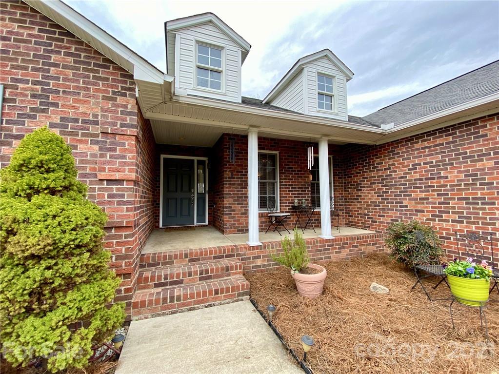 1168 Balfour Quarry Road Salisbury, NC 28146 - Photo 5 of 47 a view of a brick house with potted plants