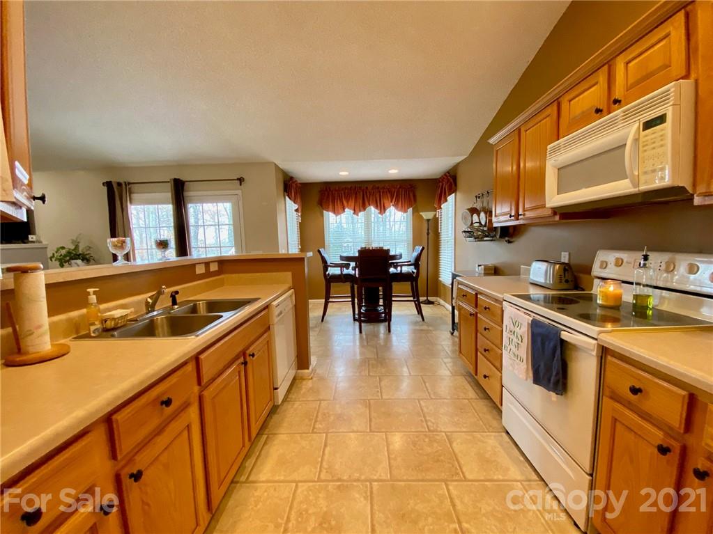 1168 Balfour Quarry Road Salisbury, NC 28146 - Photo 10 of 47 a large kitchen with stainless steel appliances granite countertop a lot of counter space and a sink