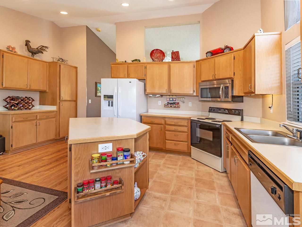7710 Pickering Circle Reno, NV 89511 - Photo 3 of 16 a kitchen with stainless steel appliances a stove a sink dishwasher and a refrigerator