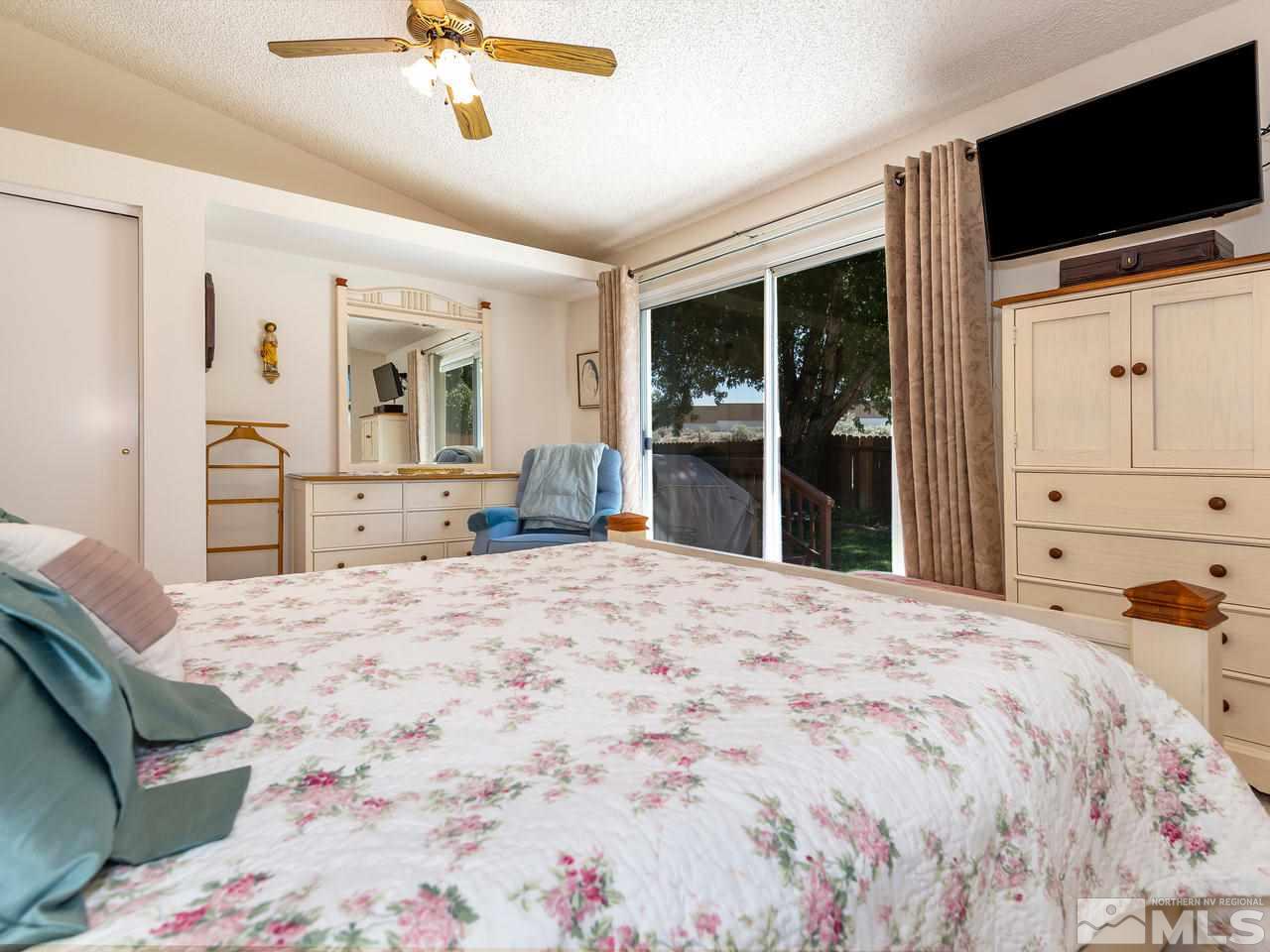 7710 Pickering Circle Reno, NV 89511 - Photo 8 of 16 a bedroom with a bed and a flat screen tv