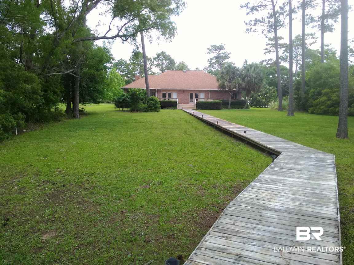 8132 Bay View Drive Foley, AL 36535 - Photo 37 of 50 Back yard and boardwalk