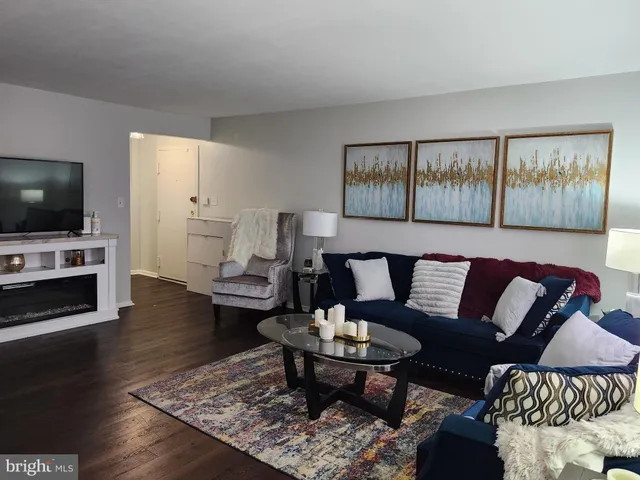 a bedroom with a bed and a flat tv screen on dresser