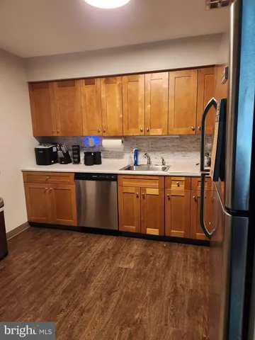 a kitchen with stainless steel appliances granite countertop a sink counter space and a large window