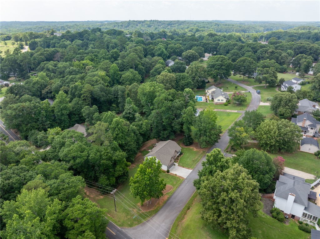 201 Hearthstone Drive Anderson, SC 29621 - Photo 39 of 49 An aerial perspective reveals a secluded residential community nestled amongst abundant greenery, with individual homes and a distant pool.