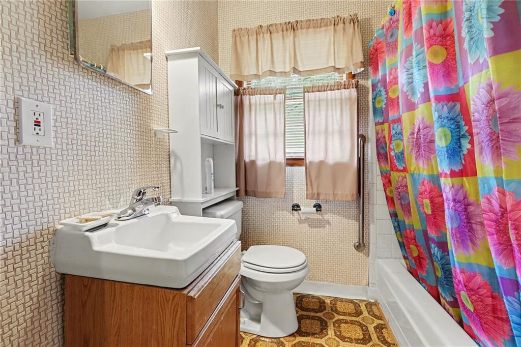 7019 Lake View Lane Doraville, GA 30360 - Photo 16 of 32 a bathroom with a sink toilet and shower