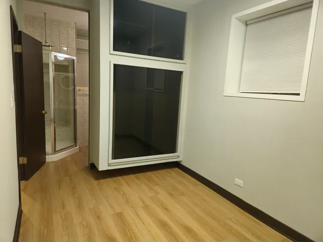 a bathroom with a granite countertop sink a vanity and a shower