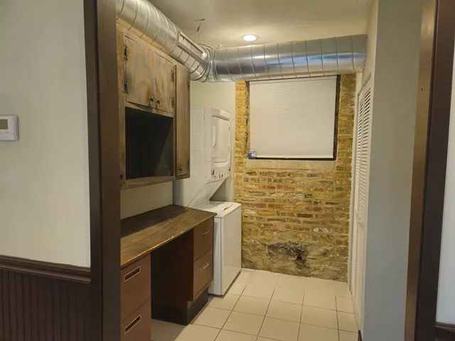 a kitchen with stainless steel appliances kitchen island granite countertop a refrigerator and a sink