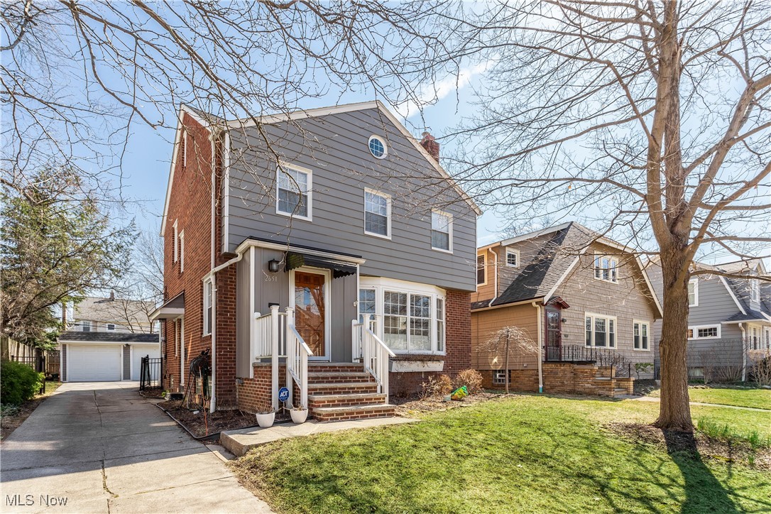 2651 Shaker Road Cleveland Heights, OH 44118 - Photo 1 of 28 View of front facade with an outdoor structure, a chimney, a front lawn, and brick siding