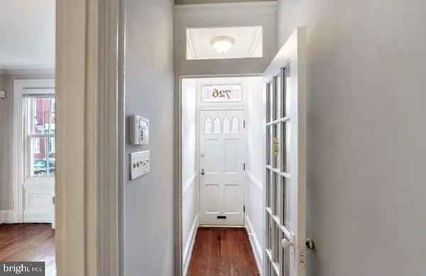 an empty room with wooden floor and a window