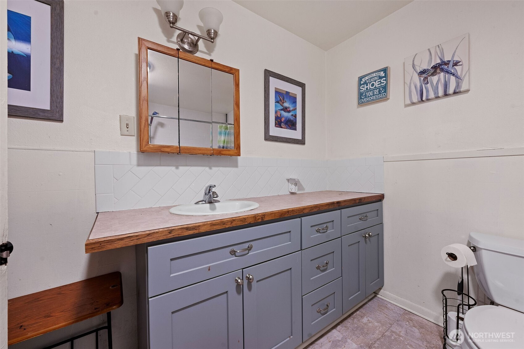 1218 Cedar Street Raymond, WA 98577 - Photo 21 of 31 a bathroom with a granite countertop sink and a mirror