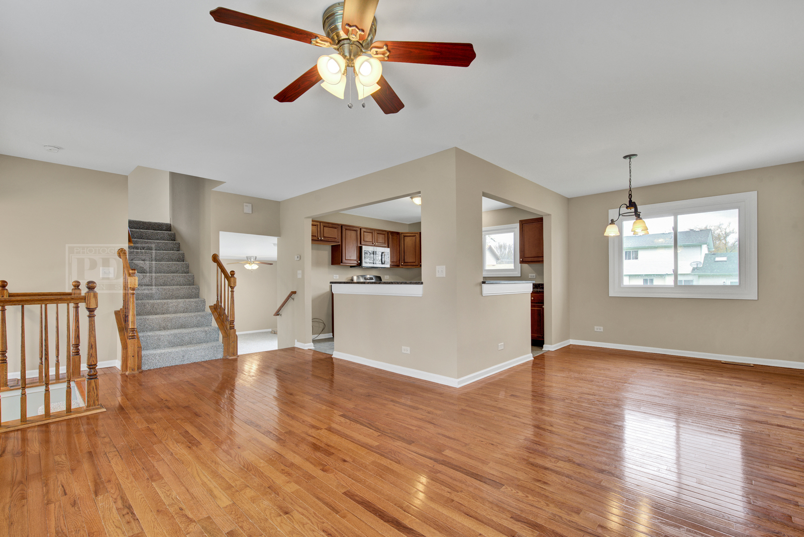 5762 Timberlane Road Matteson, IL 60443 - Photo 4 of 23 a view of an empty room with wooden floor and a window