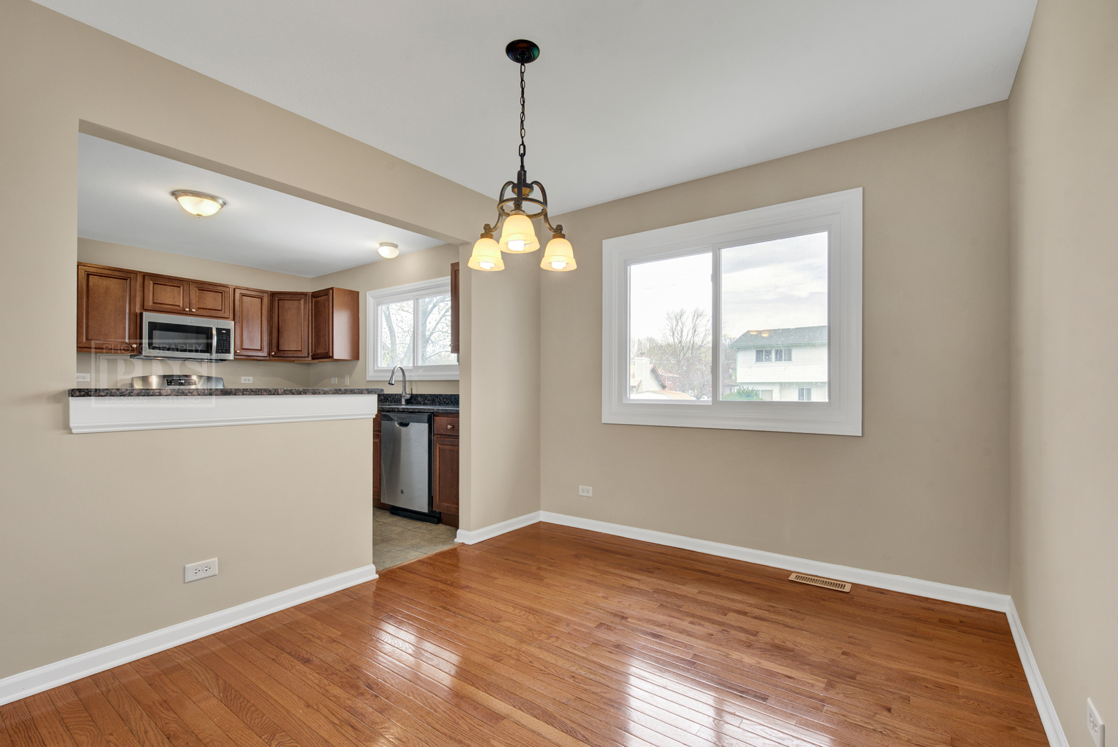 5762 Timberlane Road Matteson, IL 60443 - Photo 5 of 23 a kitchen with stainless steel appliances granite countertop a refrigerator a sink dishwasher a stove and white countertops with wooden floor