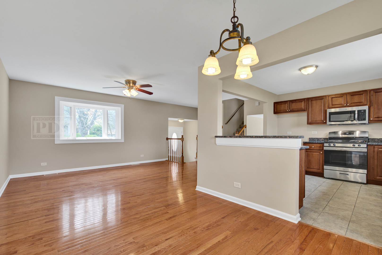 5762 Timberlane Road Matteson, IL 60443 - Photo 6 of 23 a kitchen with stainless steel appliances granite countertop a stove a sink dishwasher and a refrigerator with wooden floor